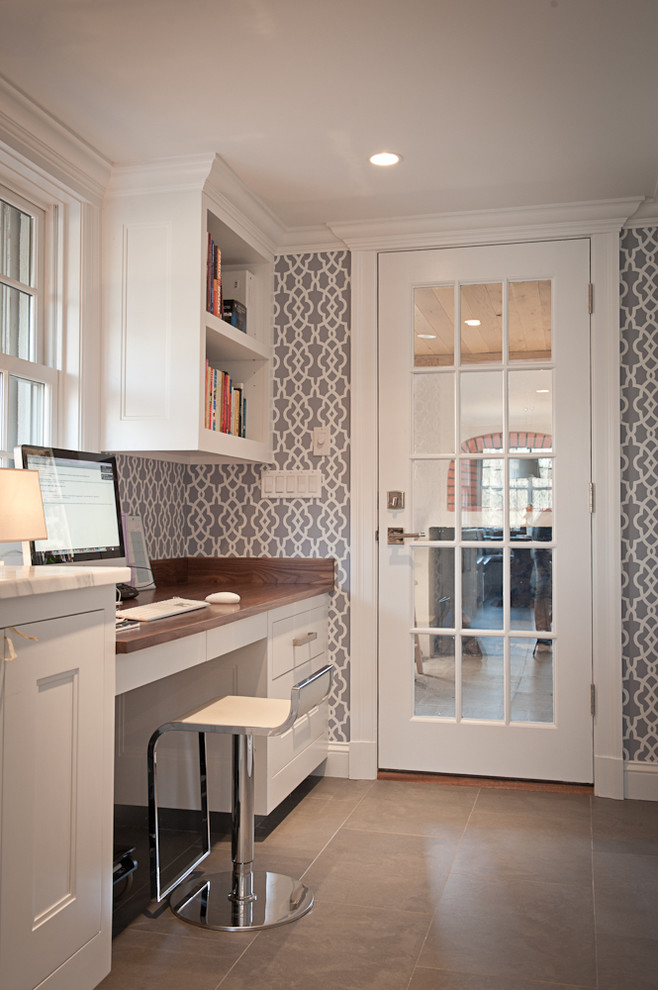 Photo of a transitional home office in New York with multi-coloured walls and a built-in desk.