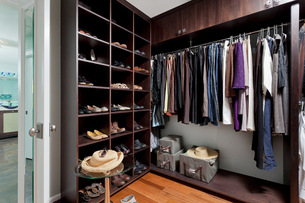 Inspiration for a contemporary storage and wardrobe in Miami with dark wood cabinets.