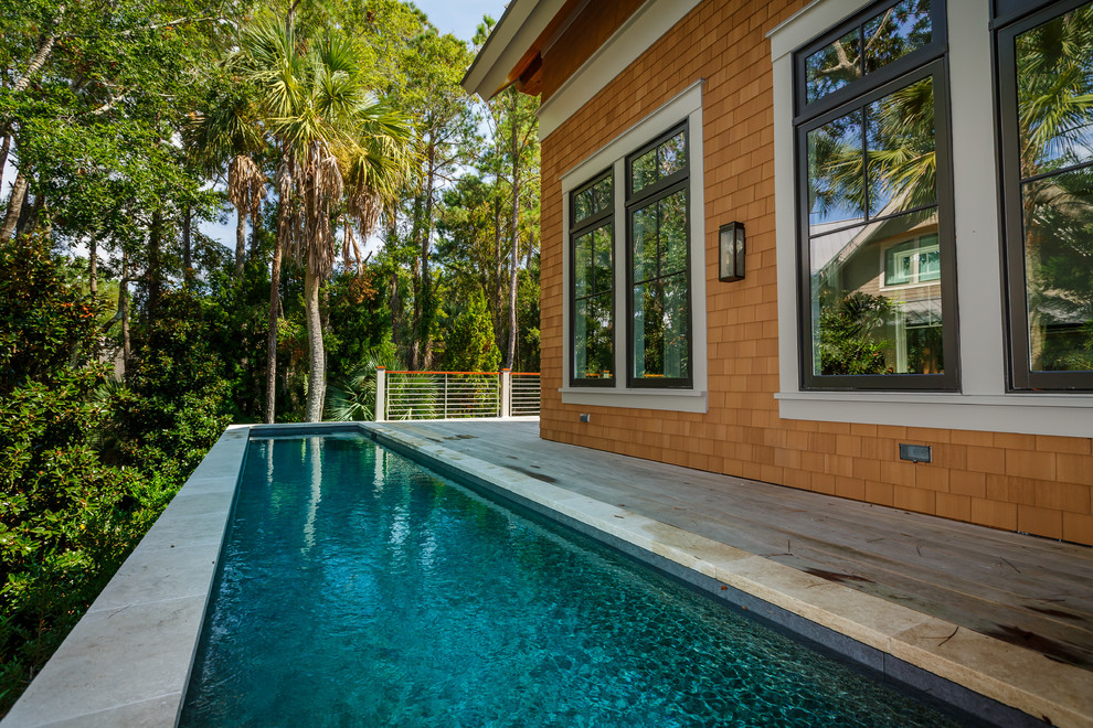 Small beach style custom-shaped aboveground pool in Charleston with decking.