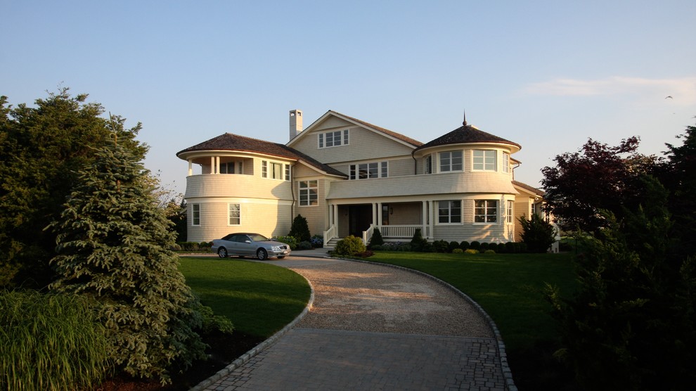 This is an example of a large traditional three-storey exterior in New York with wood siding.