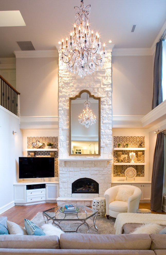 Design ideas for a large transitional open concept family room in Vancouver with grey walls, medium hardwood floors, a standard fireplace, a stone fireplace surround and a corner tv.