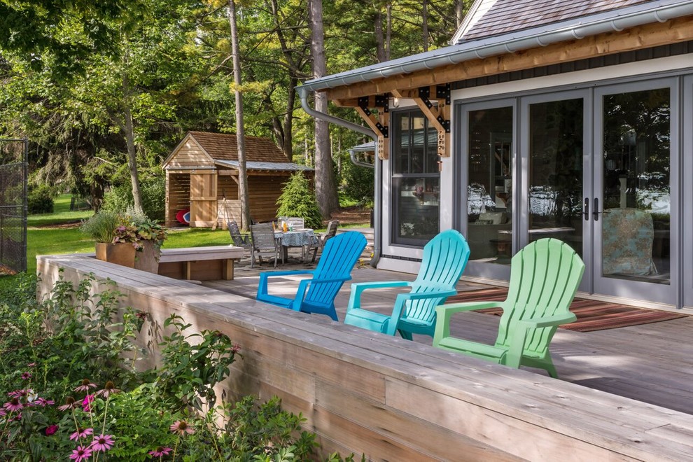 Inspiration for a large beach style backyard deck in Milwaukee with an outdoor kitchen and a roof extension.