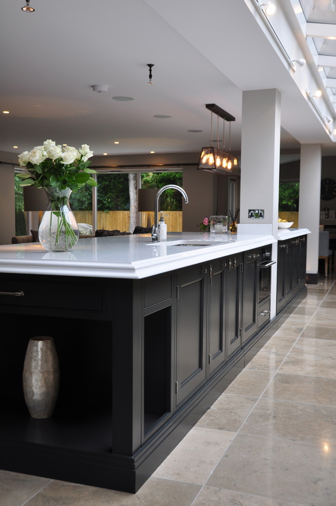 Inspiration for a large classic open plan kitchen in Cheshire with a built-in sink, shaker cabinets, grey cabinets, engineered stone countertops, grey splashback, ceramic splashback, stainless steel appliances, ceramic flooring and an island.