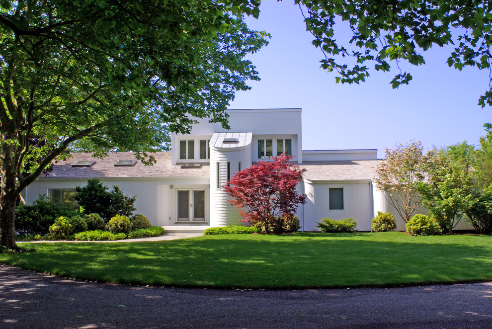 Inspiration for a large transitional white two-story brick gable roof remodel