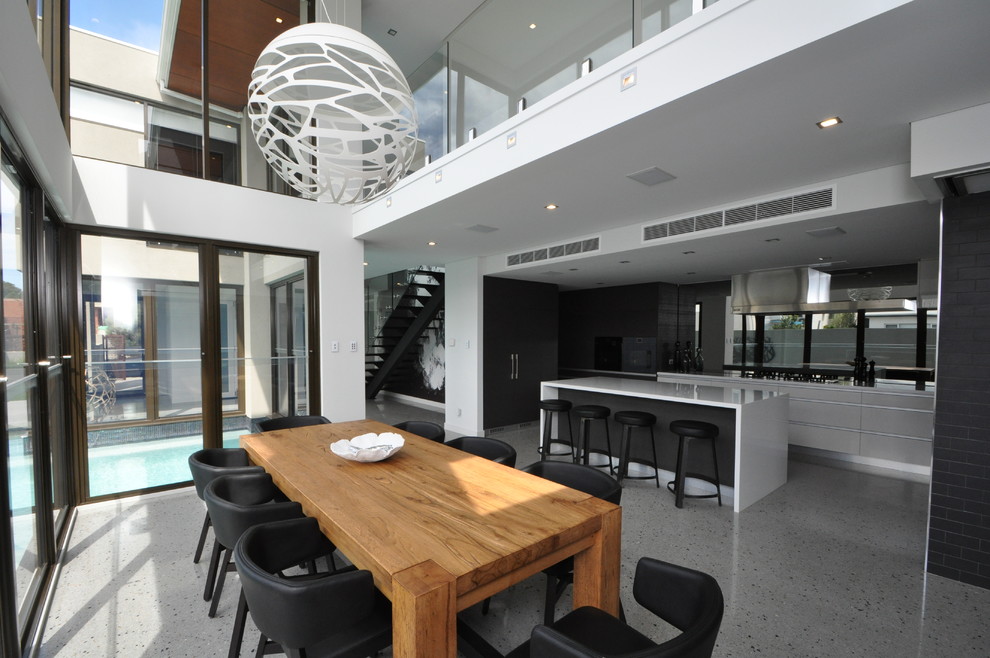 Inspiration for a large modern open plan dining in Perth with white walls and concrete floors.