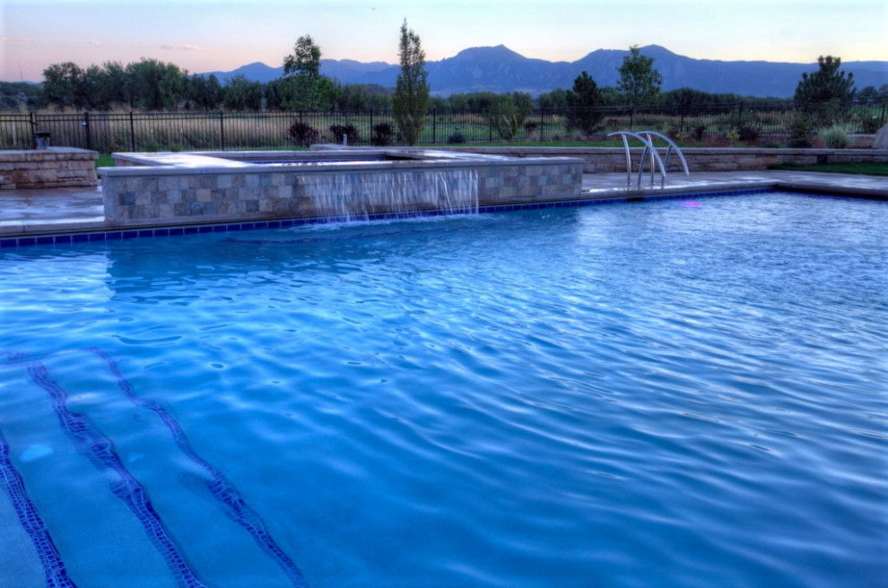 Inspiration for a large backyard rectangular water slide remodel in Denver