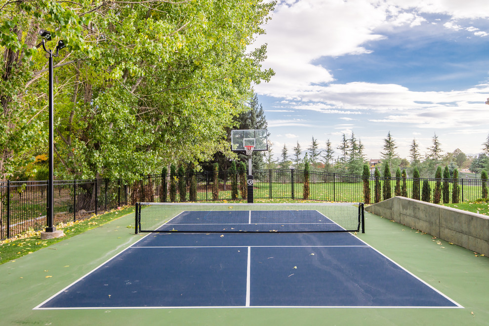 Large traditional backyard full sun outdoor sport court in Salt Lake City with a metal fence for summer.