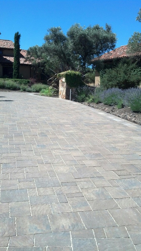 This is an example of a large mediterranean courtyard driveway in San Francisco with concrete pavers.