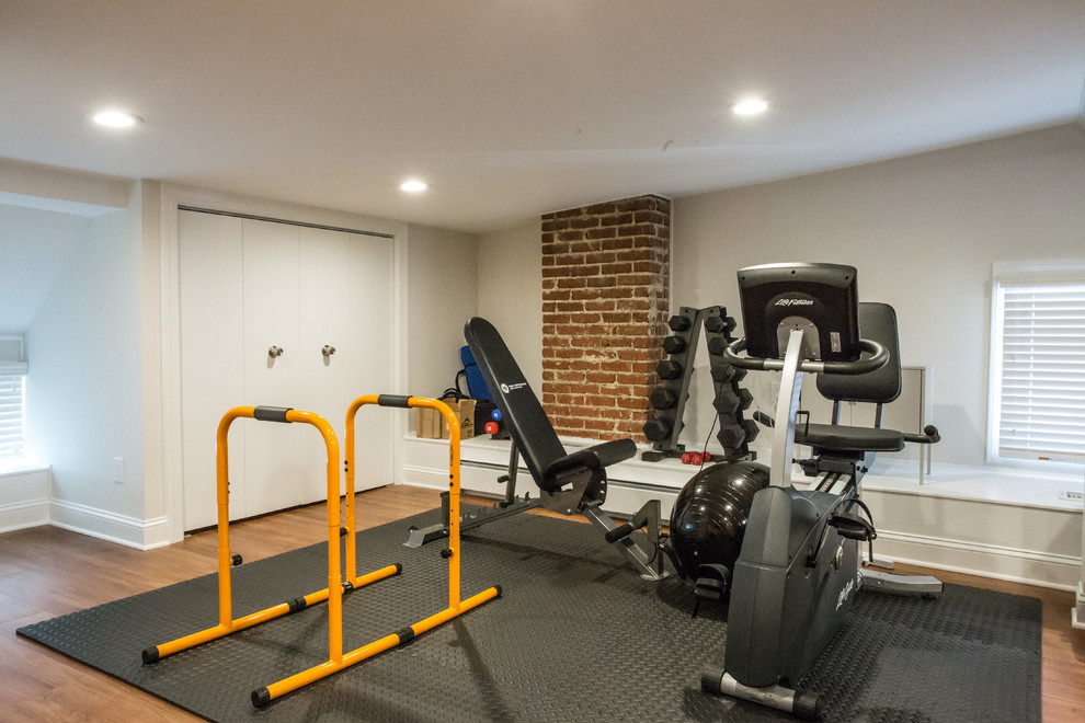 Inspiration for a mid-sized contemporary multipurpose gym in DC Metro with beige walls and medium hardwood floors.