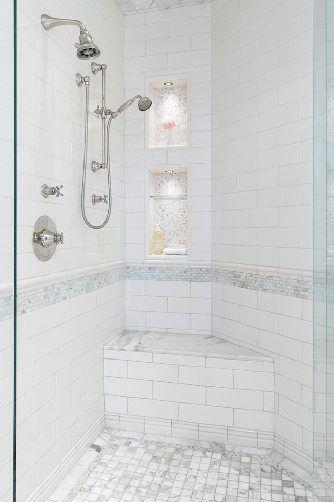 This is an example of a mid-sized transitional master bathroom in San Diego with beaded inset cabinets, white cabinets, a corner tub, a corner shower, a bidet, white tile, marble, white walls, marble floors, an undermount sink, marble benchtops, white floor, a hinged shower door and brown benchtops.