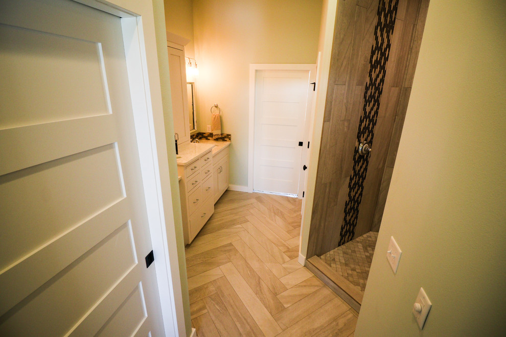 Photo of a mid-sized contemporary master bathroom in Other with recessed-panel cabinets, white cabinets, an alcove shower, a one-piece toilet, white tile, porcelain tile, white walls, porcelain floors, an undermount sink, engineered quartz benchtops, beige floor and a shower curtain.