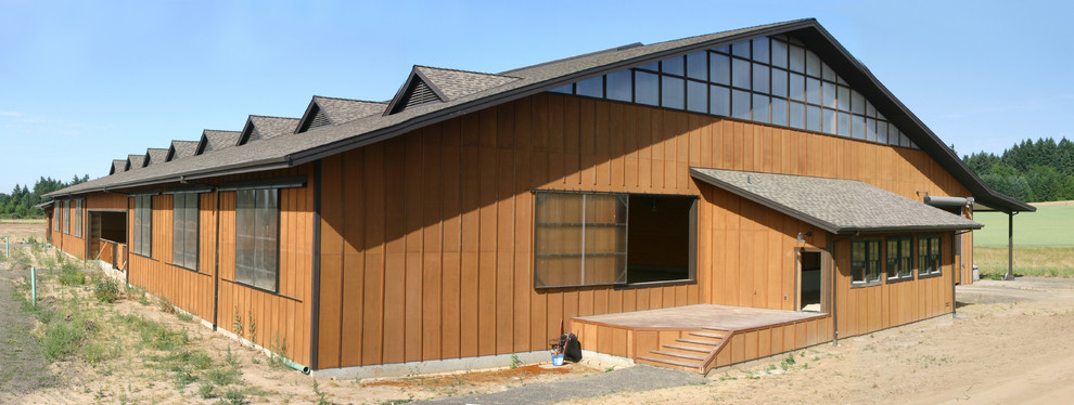 This is an example of an expansive traditional brown exterior in Portland with wood siding.