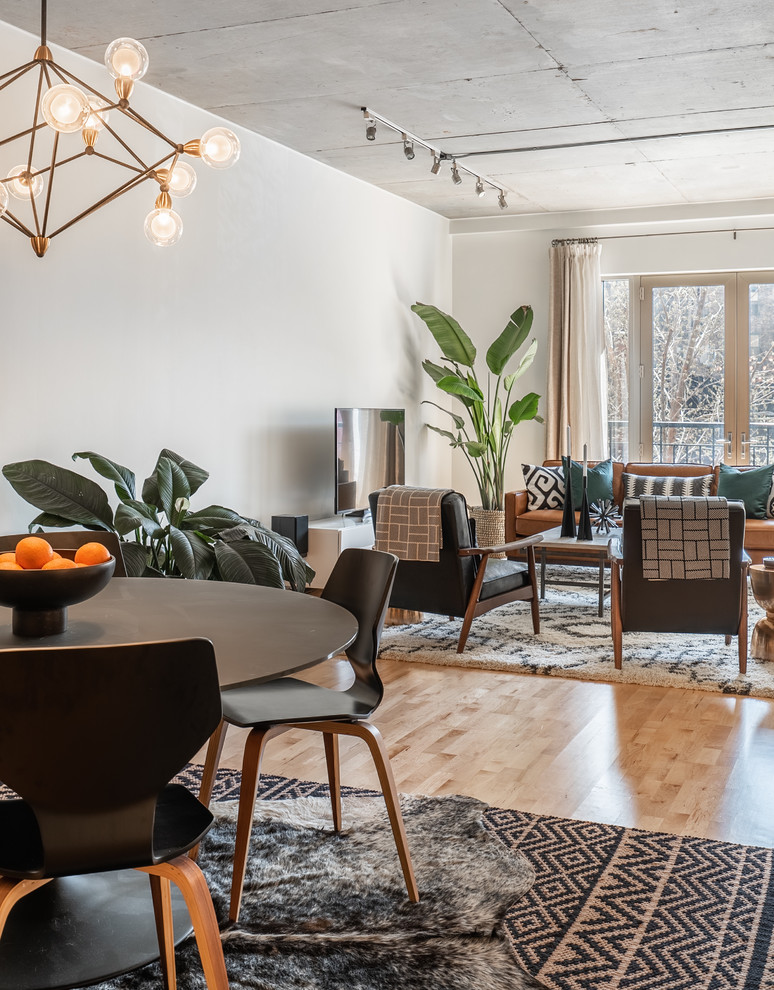 Example of a mid-sized urban open concept light wood floor and brown floor living room design in Phoenix with white walls, no fireplace and a tv stand