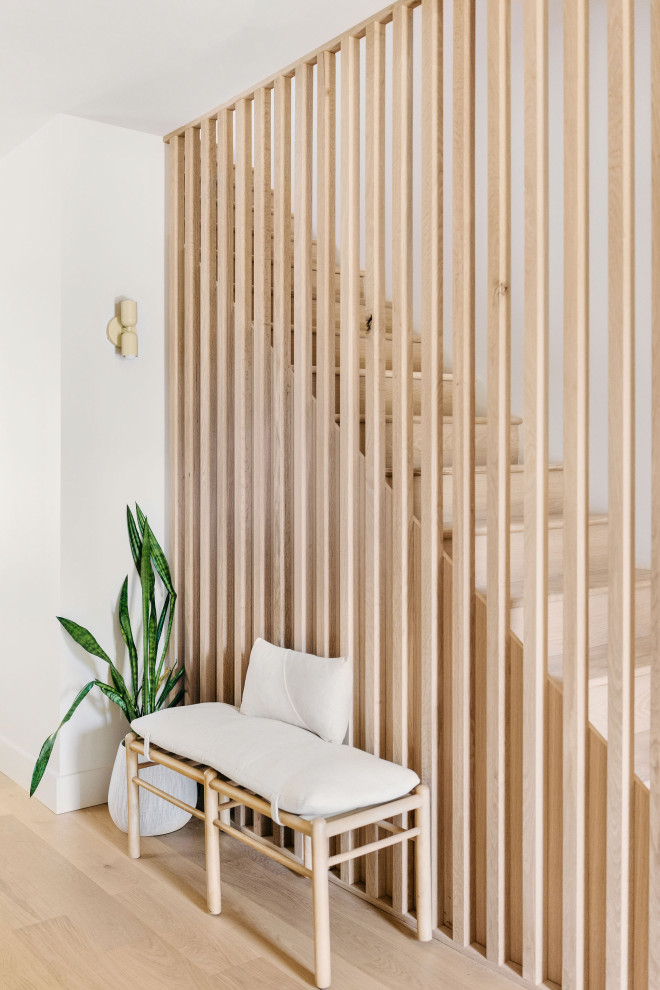 Example of a small danish wooden straight wood railing staircase design with wooden risers