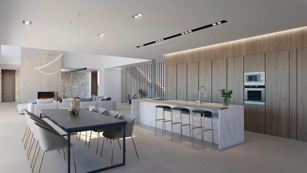 This is an example of an expansive contemporary galley eat-in kitchen in Palma de Mallorca with an undermount sink, flat-panel cabinets, medium wood cabinets, panelled appliances, with island, grey floor and grey benchtop.