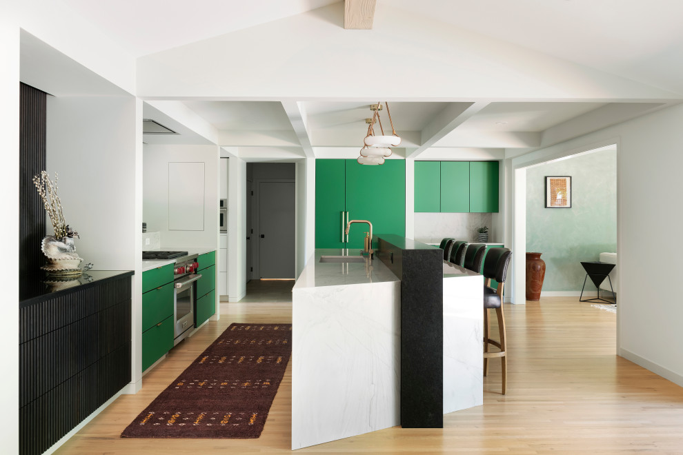 Photo of a midcentury l-shaped kitchen in Minneapolis with an undermount sink, flat-panel cabinets, green cabinets, stainless steel appliances, light hardwood floors, with island, beige floor, white benchtop and coffered.