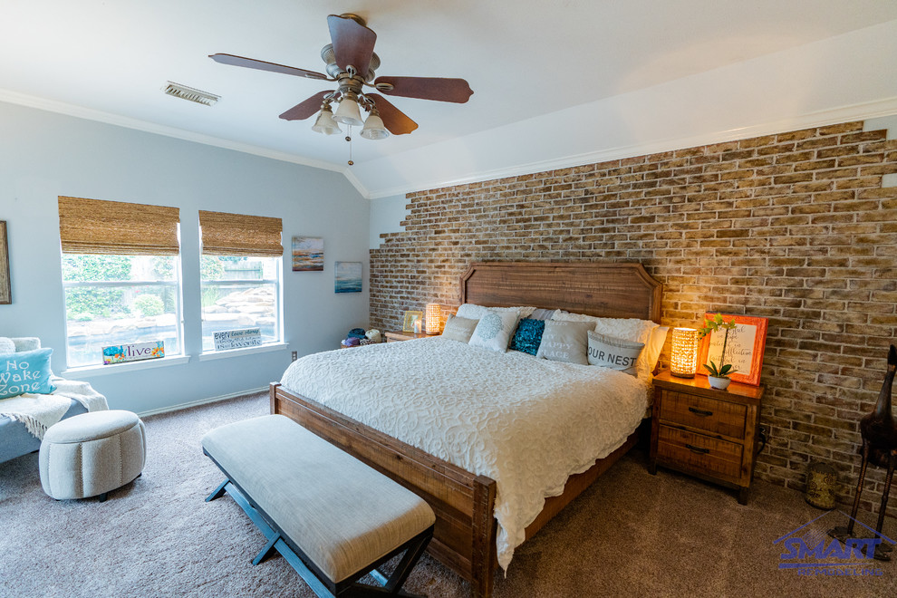 Inspiration for a mid-sized traditional master bedroom in Houston with grey walls, carpet, no fireplace, beige floor, coffered and brick walls.