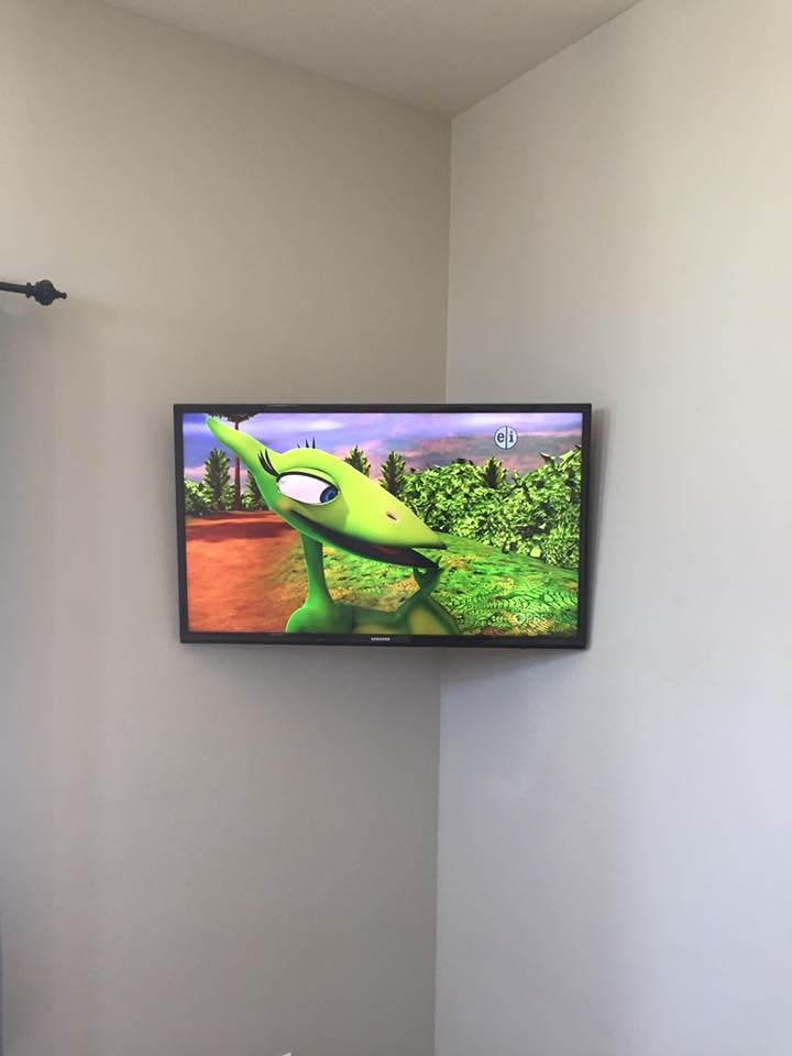 Inspiration for a mid-sized transitional enclosed living room remodel in Phoenix with a wall-mounted tv and beige walls