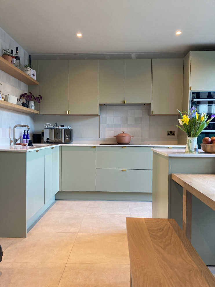 Contemporary kitchen in Surrey with flat-panel cabinets, green cabinets, quartz worktops and white worktops.