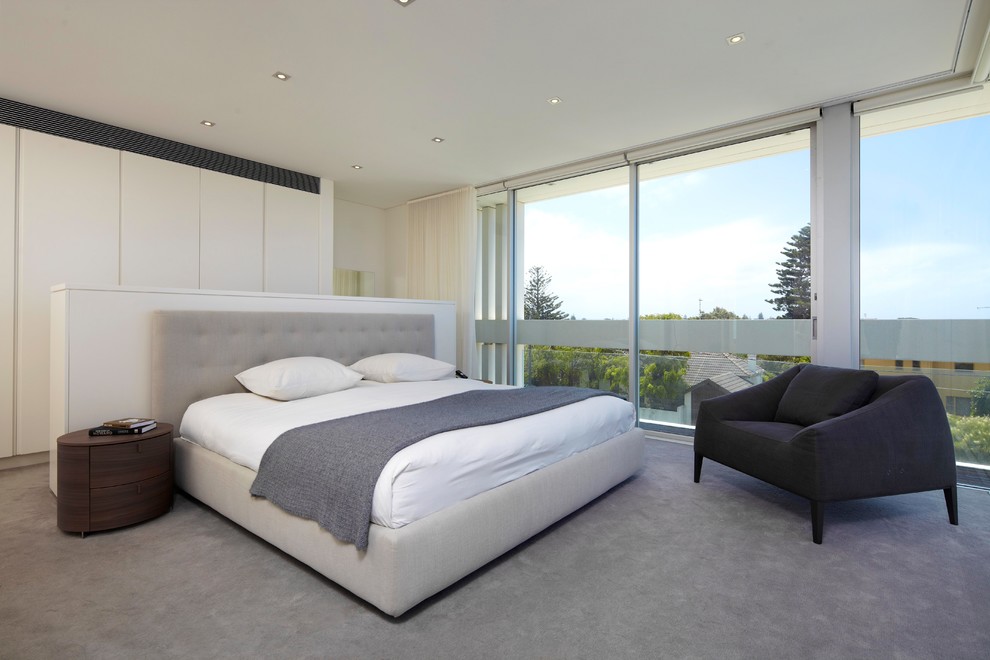 Contemporary master bedroom in Sydney with beige walls, carpet and grey floor.