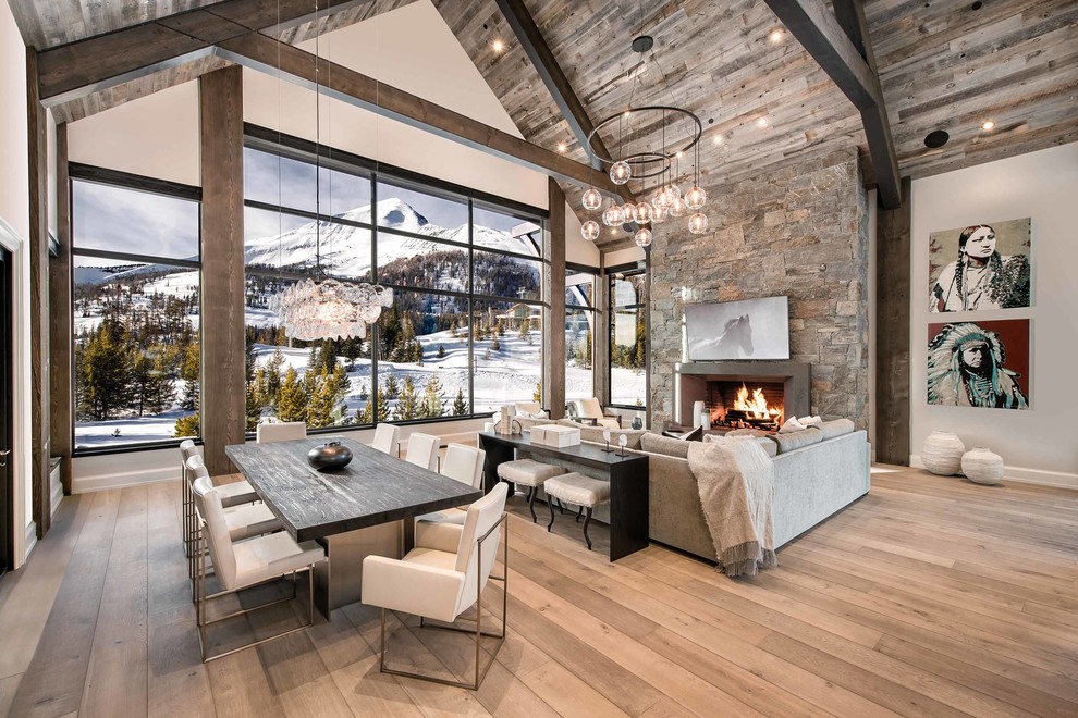 Inspiration for a country open concept living room in Other with grey walls, medium hardwood floors, a standard fireplace and brown floor.