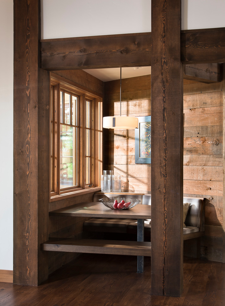 Inspiration for a rustic dark wood floor and brown floor dining room remodel with brown walls