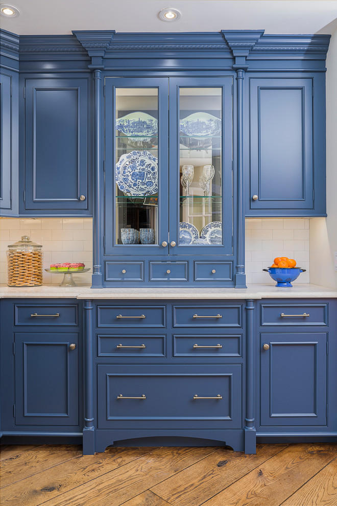 Inspiration for a small traditional l-shaped separate kitchen in New York with a farmhouse sink, beaded inset cabinets, blue cabinets, soapstone benchtops, white splashback, subway tile splashback, panelled appliances, medium hardwood floors and no island.