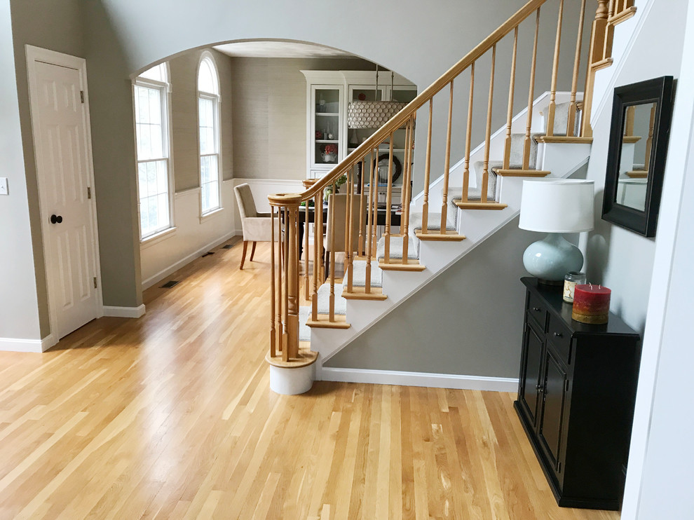 Design ideas for an entryway in Boston with grey walls and light hardwood floors.