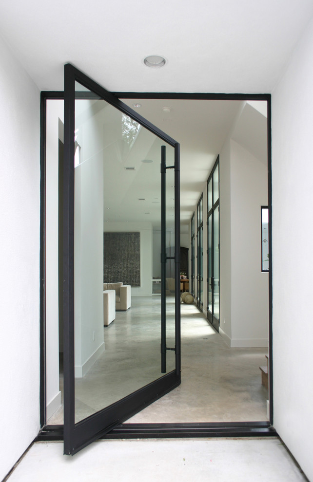 Design ideas for a modern entryway in Houston with concrete floors.