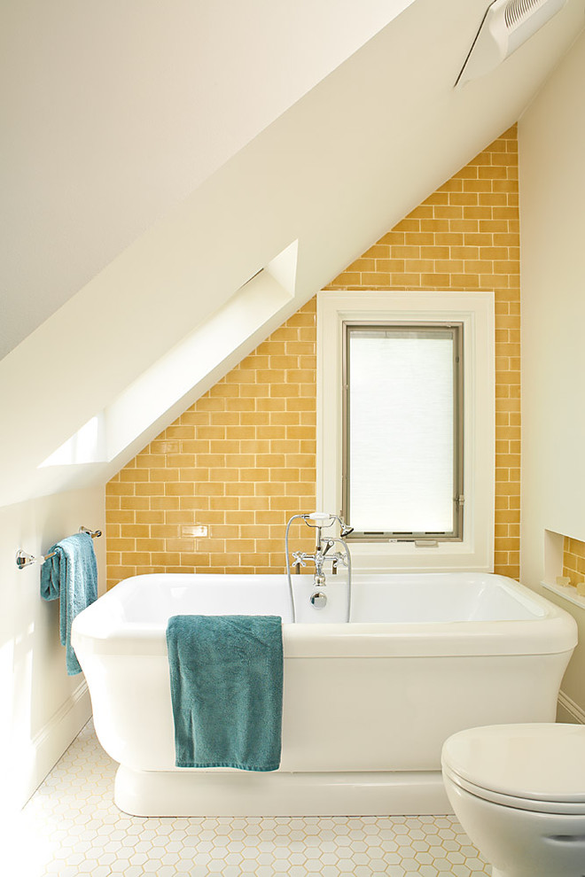 Photo of a beach style bathroom in Atlanta with a freestanding tub, subway tile, yellow tile, yellow walls, mosaic tile floors and white floor.