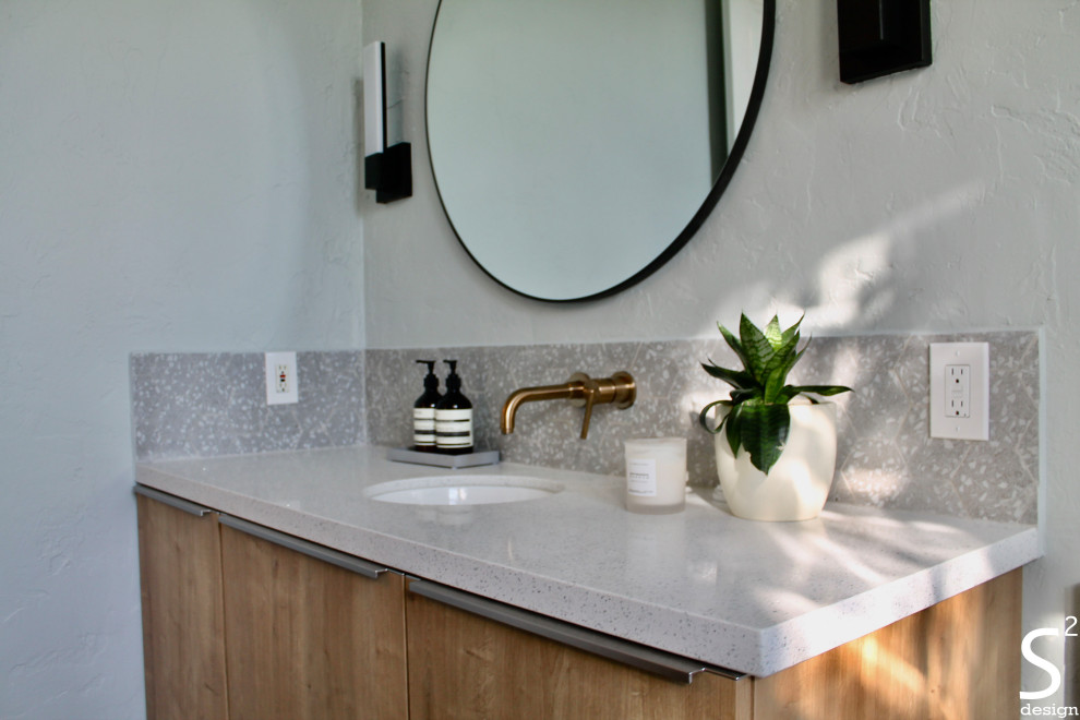 This is an example of a mid-sized midcentury bathroom in Houston with flat-panel cabinets, light wood cabinets, a freestanding tub, a bidet, gray tile, porcelain tile, grey walls, concrete floors, an undermount sink, engineered quartz benchtops, grey floor, white benchtops, a niche, a single vanity and a floating vanity.