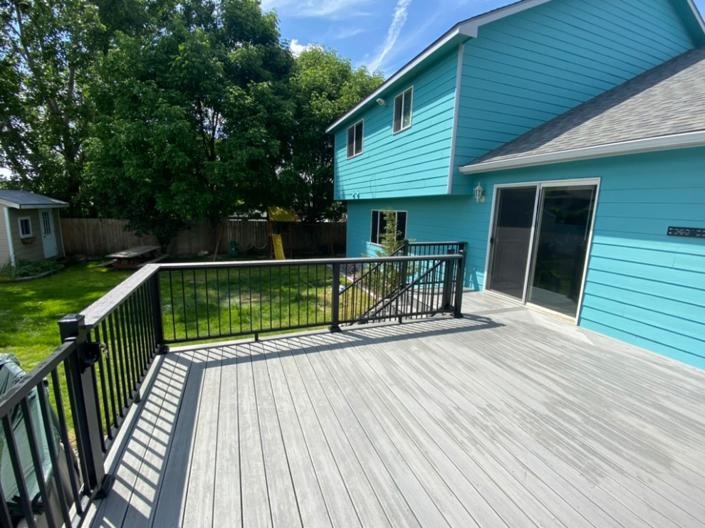 Large backyard metal railing deck photo in Seattle