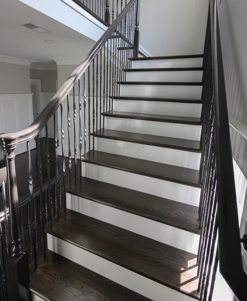 Large transitional wood floating staircase in DC Metro with wood risers and mixed railing.