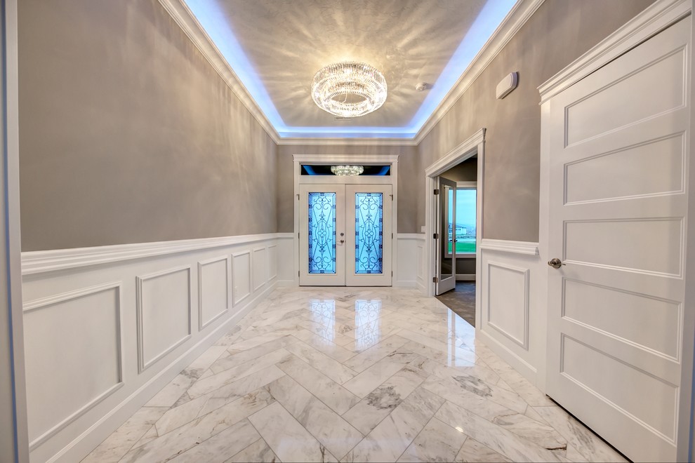 Inspiration for a mid-sized transitional marble floor and white floor foyer remodel in Seattle with gray walls and a white front door