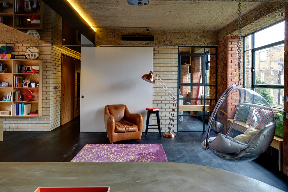 Design ideas for an industrial living room in London with beige walls, dark hardwood floors and black floor.