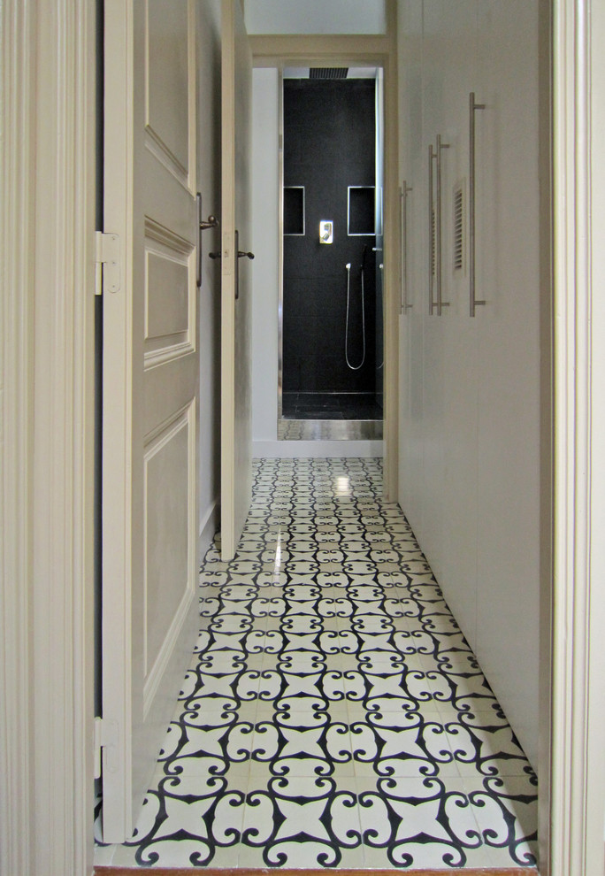 Design ideas for a small transitional hallway in Malaga with white walls and ceramic floors.