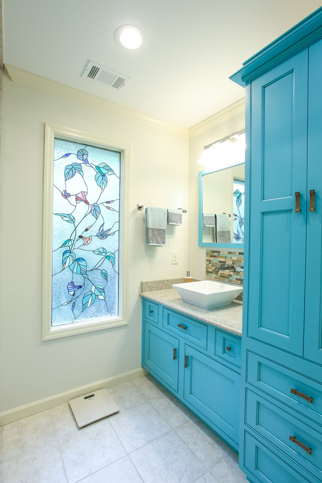 Photo of a mid-sized beach style bathroom in Atlanta with beaded inset cabinets, blue cabinets, mirror tile, white walls, limestone floors, a vessel sink and soapstone benchtops.