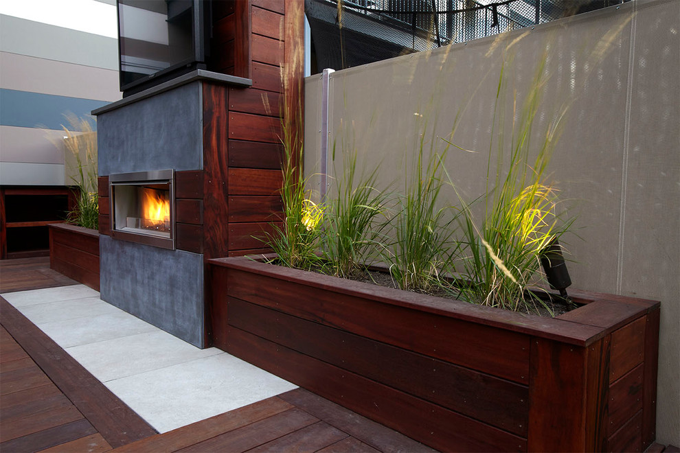 Inspiration for a mid-sized contemporary rooftop deck in Chicago with a fire feature.