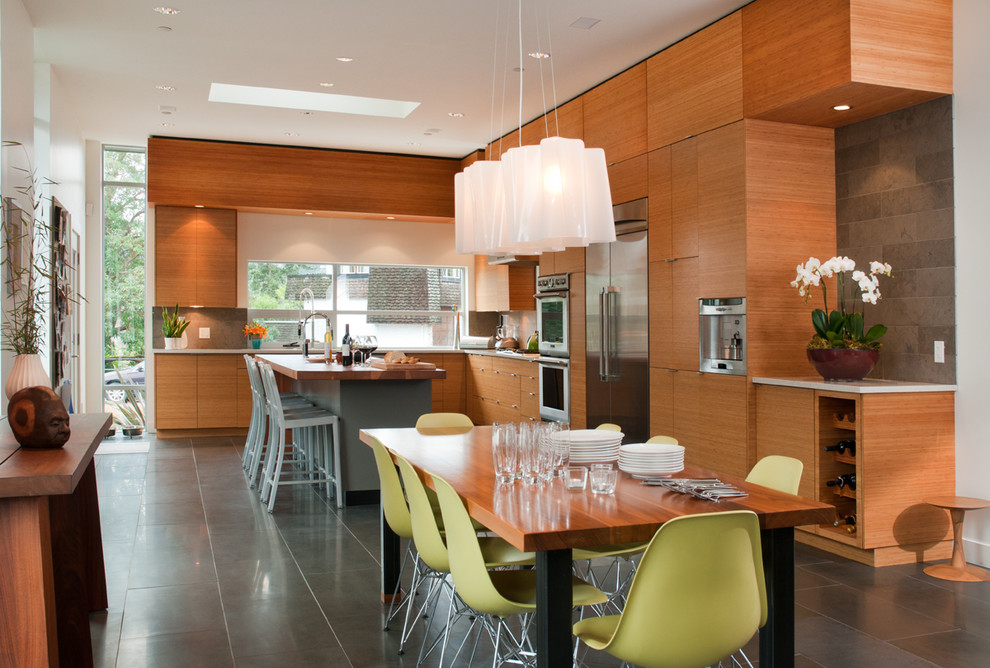 Inspiration for a contemporary l-shaped open plan kitchen in Vancouver with flat-panel cabinets, medium wood cabinets and stainless steel appliances.