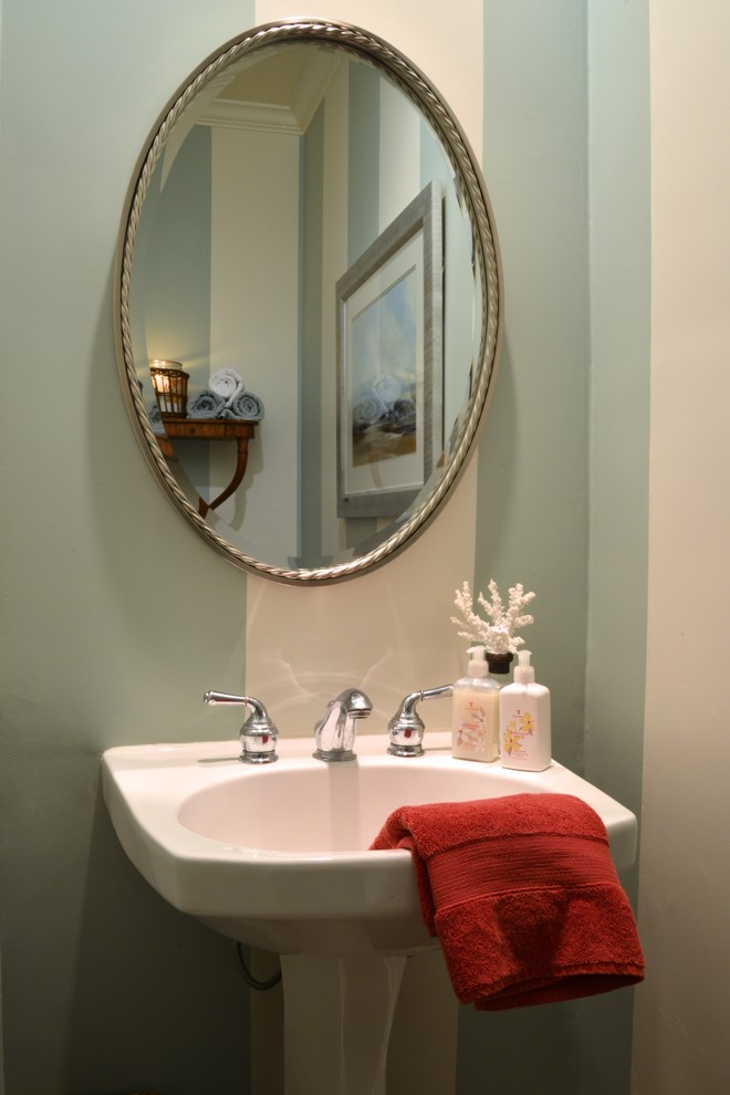 Photo of a beach style powder room in San Diego with blue walls, dark hardwood floors and a pedestal sink.