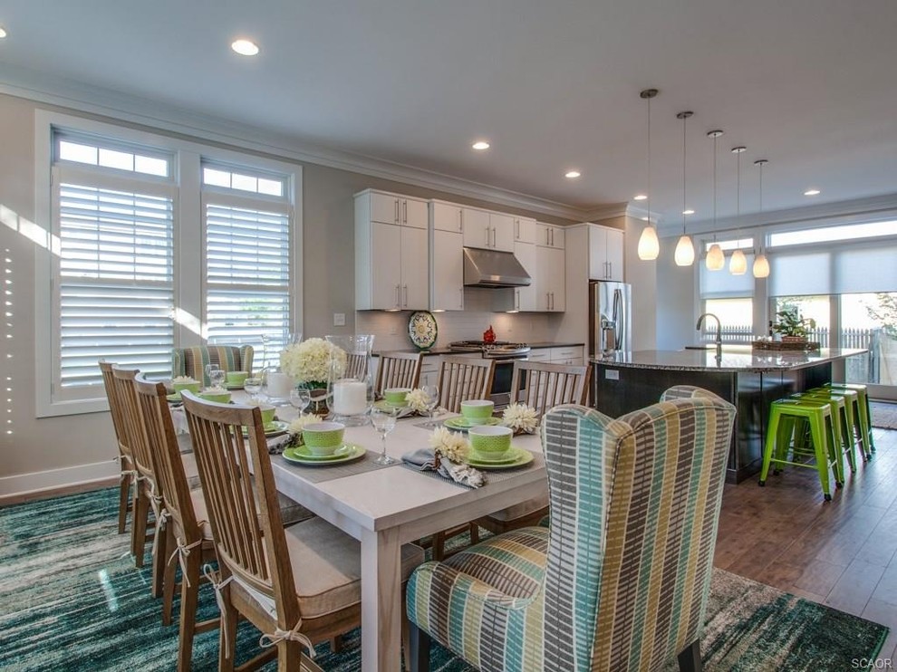 Large transitional dark wood floor and brown floor kitchen/dining room combo photo with no fireplace and beige walls