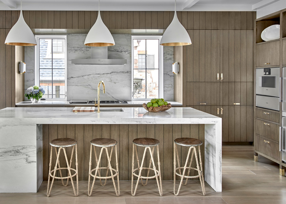Design ideas for a contemporary l-shaped eat-in kitchen in Chicago with an undermount sink, flat-panel cabinets, quartzite benchtops, white splashback, panelled appliances, light hardwood floors, with island, white benchtop, medium wood cabinets and beige floor.