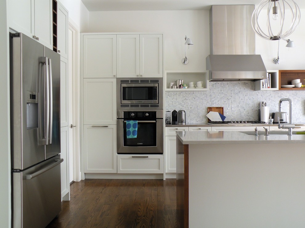 Open concept kitchen - large transitional galley dark wood floor open concept kitchen idea in Ottawa with an undermount sink, shaker cabinets, white cabinets, quartzite countertops, mosaic tile backsplash, stainless steel appliances and an island
