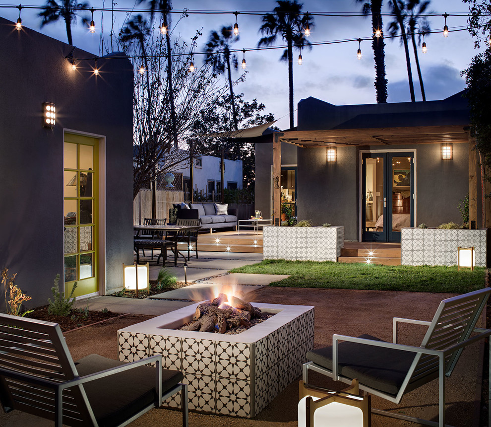 Mid-sized arts and crafts backyard patio in San Diego with a fire feature and concrete pavers.
