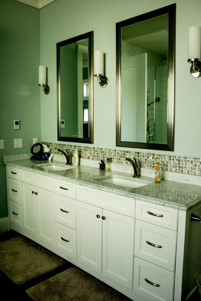 This is an example of a mid-sized contemporary master bathroom in Vancouver with an undermount sink, flat-panel cabinets, white cabinets, brown tile, green tile, white tile, mosaic tile, green walls, marble benchtops, a two-piece toilet and dark hardwood floors.
