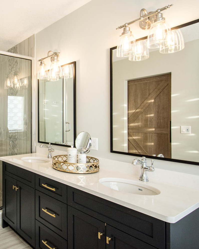 Mid-sized transitional master gray tile and porcelain tile porcelain tile and gray floor freestanding bathtub photo in Calgary with recessed-panel cabinets, black cabinets, gray walls, an undermount sink, quartz countertops and a hinged shower door