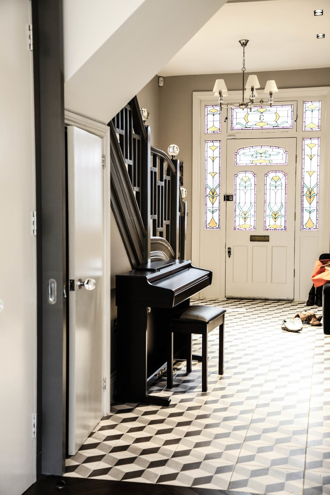 Photo of a traditional foyer in London with linoleum floors, a single front door and a white front door.