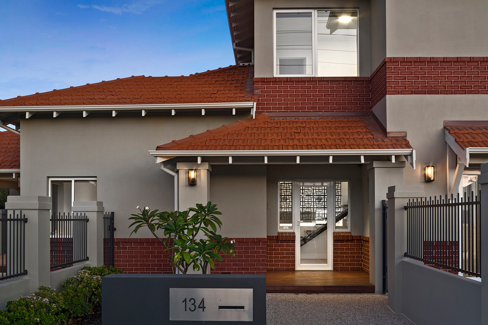 Photo of a large traditional two-storey brick beige house exterior in Perth with a hip roof and a tile roof.