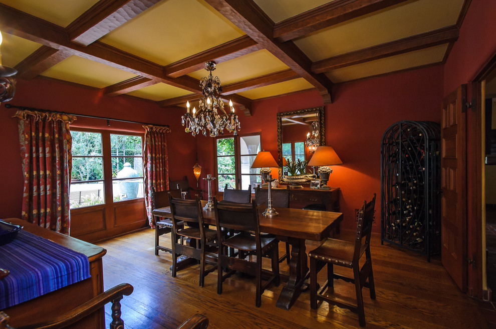 Photo of a traditional dining room in San Francisco with red walls and dark hardwood floors.