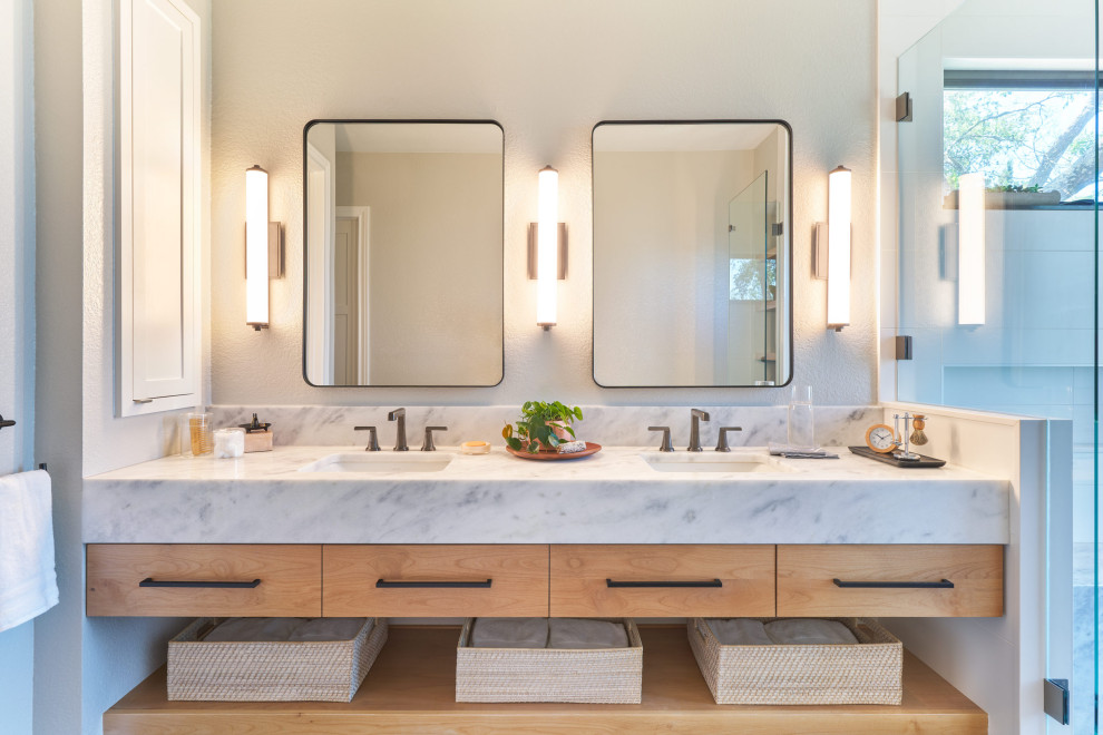 Inspiration for a mid-sized contemporary master blue tile blue floor and double-sink shower bench remodel in Austin with flat-panel cabinets, light wood cabinets, white walls, an undermount sink, marble countertops and a floating vanity